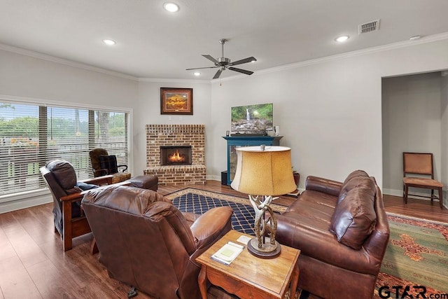 11317 Lindsey Gdns, Tyler, TX 75709 - living room with wood finished floors, ceiling fan, crown molding, recessed lighting, and a fireplace