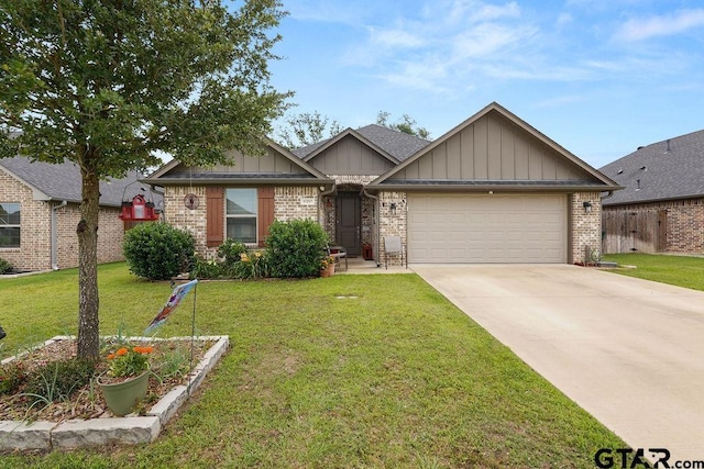11317 Lindsey Gdns, Tyler, TX 75709 - view of front of house with board and batten siding, a garage, driveway, a front yard, and brick siding