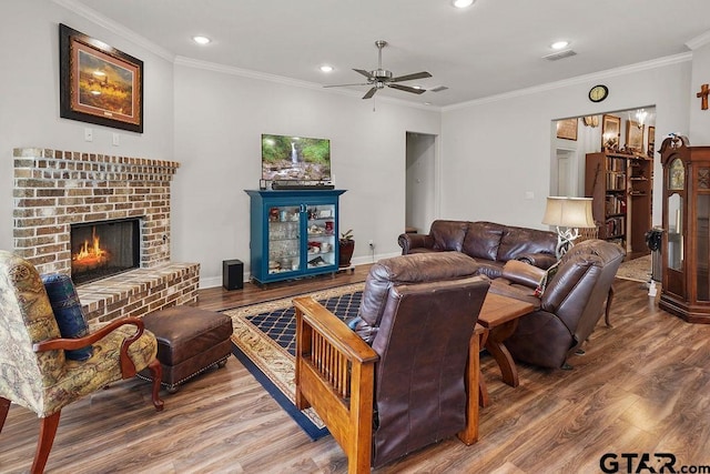 11317 Lindsey Gdns, Tyler, TX 75709 - living area with wood finished floors, a ceiling fan, ornamental molding, recessed lighting, and a fireplace