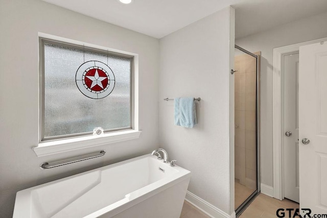 11317 Lindsey Gdns, Tyler, TX 75709 - full bath with a bath, a shower stall, and baseboards