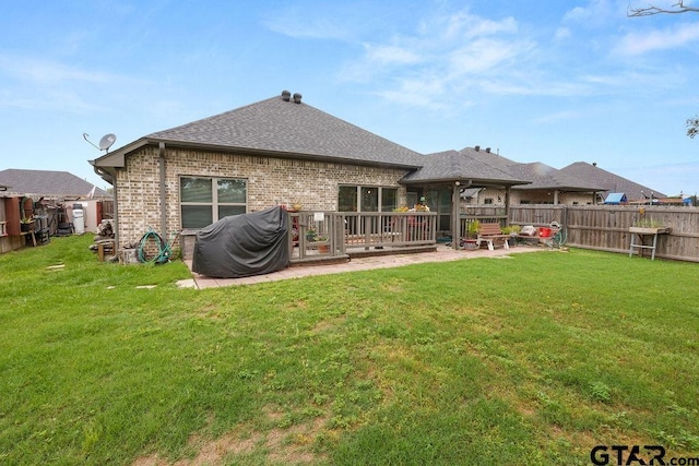 11317 Lindsey Gdns, Tyler, TX 75709 - rear view of property featuring a shingled roof, brick siding, and a patio area