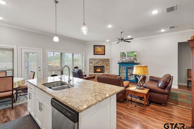 11317 Lindsey Gdns, Tyler, TX 75709 - kitchen featuring stainless steel dishwasher, a sink, ornamental molding, a fireplace, and ceiling fan