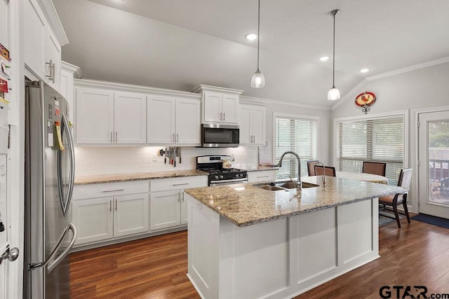 11317 Lindsey Gdns, Tyler, TX 75709 - kitchen with appliances with stainless steel finishes, vaulted ceiling, a sink, ornamental molding, and tasteful backsplash