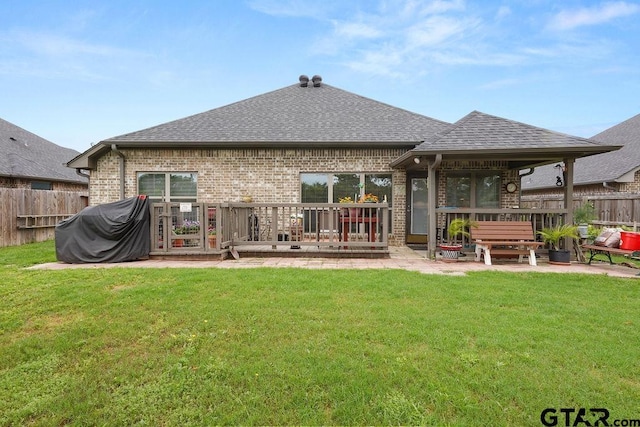 11317 Lindsey Gdns, Tyler, TX 75709 - rear view of house with a shingled roof, brick siding, a wooden deck, and a patio area