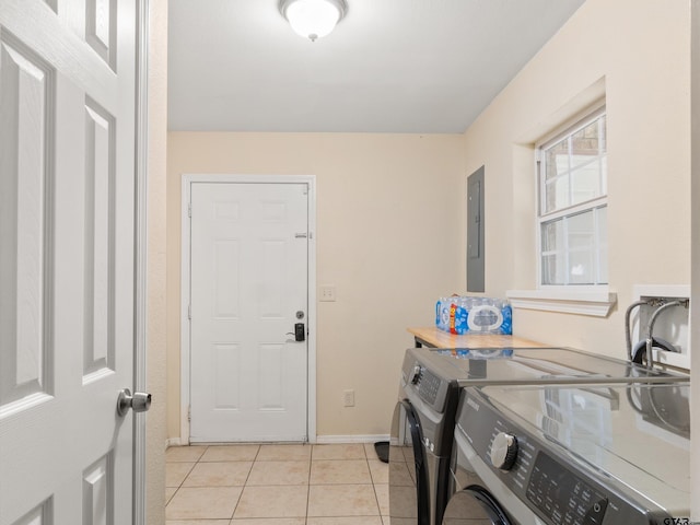 laundry room featuring light tile patterned floors, electric panel, and separate washer and dryer