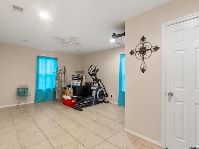 exercise room featuring light tile patterned flooring and ceiling fan