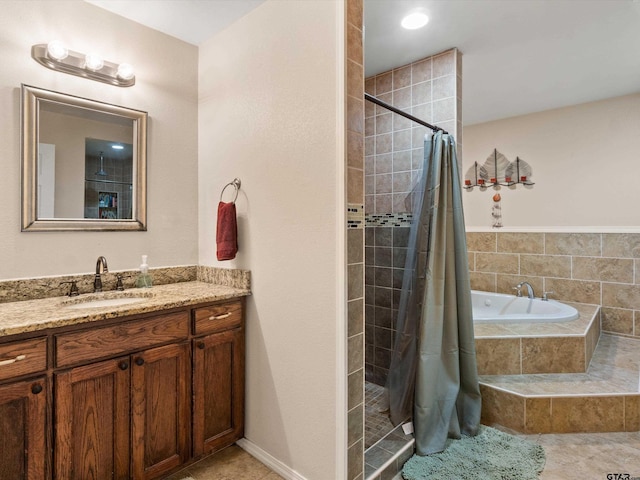 bathroom with tile patterned floors, vanity, and shower with separate bathtub