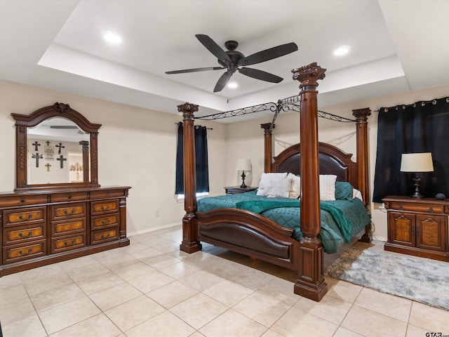 bedroom featuring a tray ceiling, ceiling fan, and light tile patterned flooring