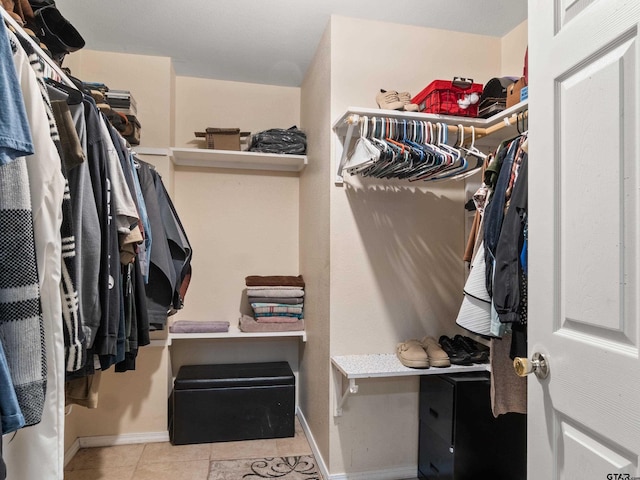 walk in closet featuring light tile patterned flooring