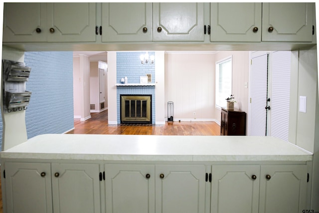 3008 Oak Knob Dr, Tyler, TX 75701 - kitchen with light wood-style floors, light countertops, and a brick fireplace