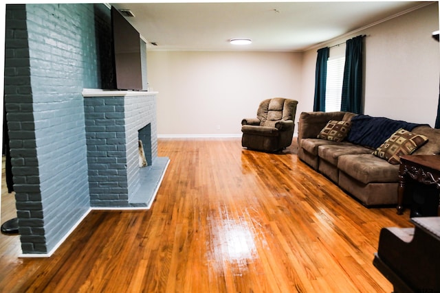 3008 Oak Knob Dr, Tyler, TX 75701 - living area featuring hardwood / wood-style flooring, a brick fireplace, and crown molding
