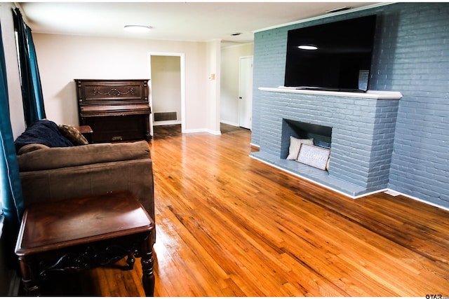 3008 Oak Knob Dr, Tyler, TX 75701 - living area featuring wood finished floors and a brick fireplace