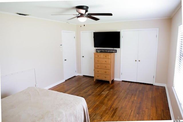 3008 Oak Knob Dr, Tyler, TX 75701 - bedroom with dark wood finished floors, multiple closets, crown molding, and a ceiling fan