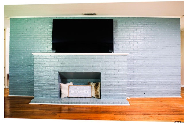 3008 Oak Knob Dr, Tyler, TX 75701 - detailed view of wood finished floors, a fireplace, and brick wall