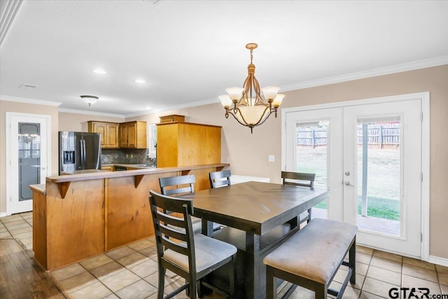 dining room featuring ornamental molding, french doors, and light tile patterned floors