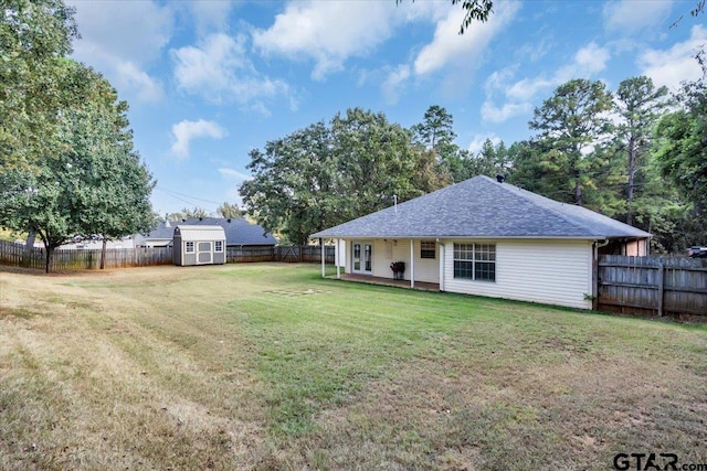 back of property featuring a shed and a lawn