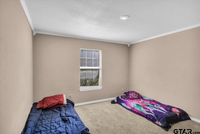 bedroom with ornamental molding and carpet floors