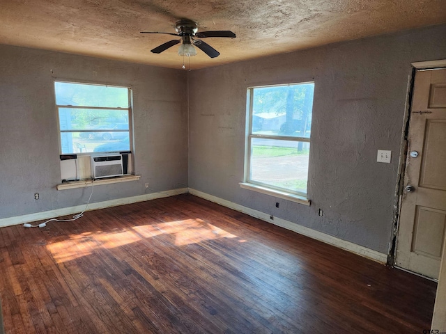unfurnished room with ceiling fan, baseboards, wood finished floors, and cooling unit