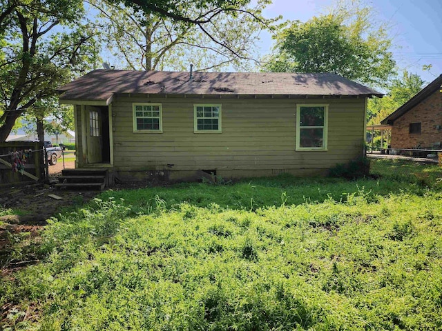 rear view of house with fence