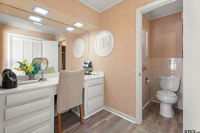 bathroom featuring vanity, hardwood / wood-style floors, ornamental molding, and toilet