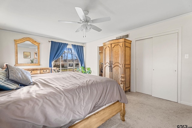 carpeted bedroom with ceiling fan and a closet