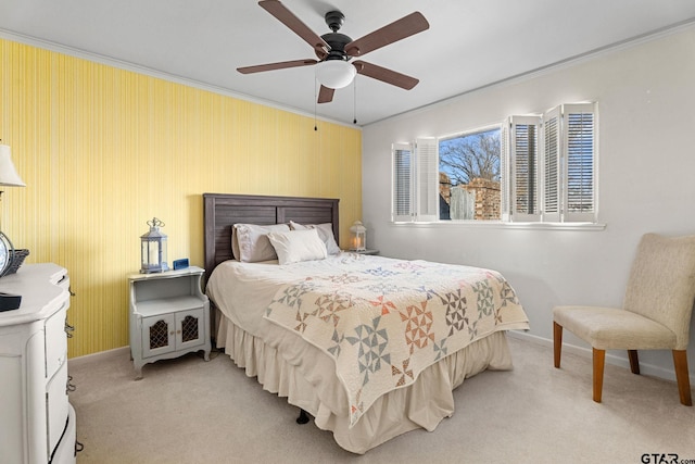 bedroom featuring crown molding, light colored carpet, and ceiling fan