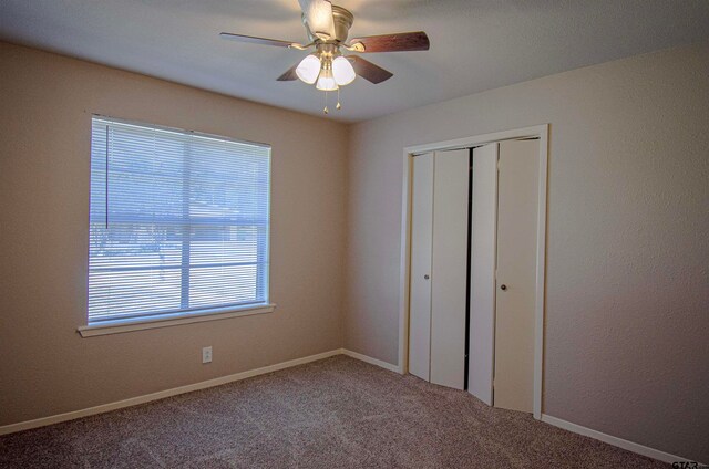 unfurnished bedroom featuring a closet, ceiling fan, and carpet floors