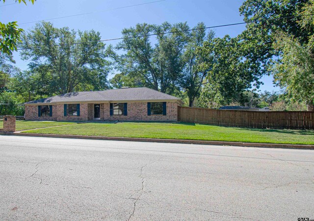 ranch-style home featuring a front lawn