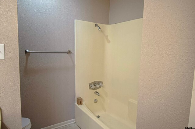 bathroom featuring toilet and tub / shower combination