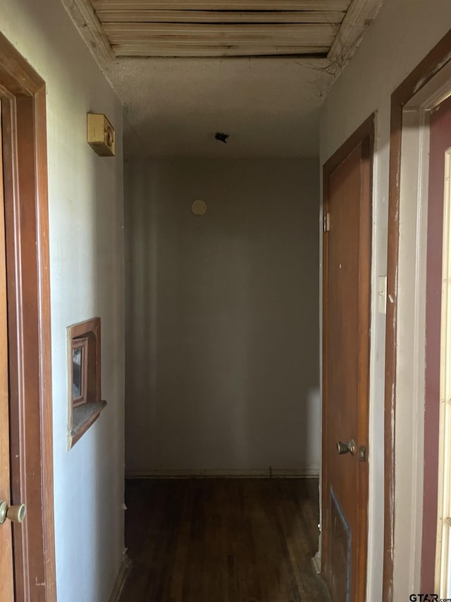 hallway with dark hardwood / wood-style floors