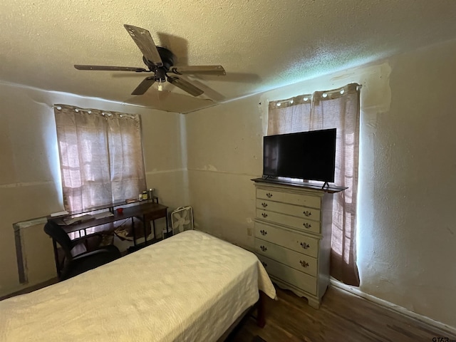 bedroom featuring a textured ceiling, dark hardwood / wood-style flooring, and ceiling fan