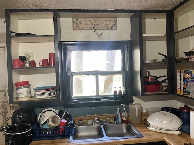 interior space featuring a textured ceiling and sink