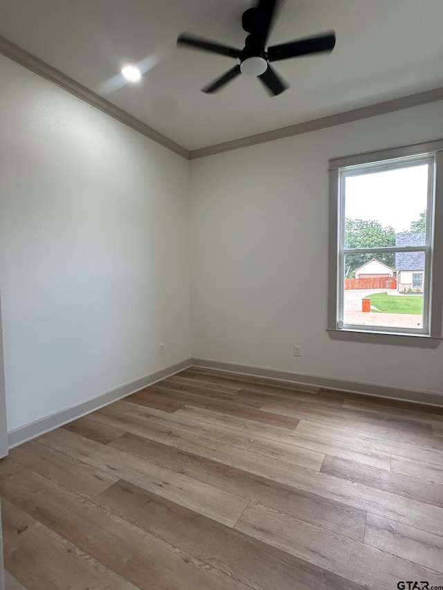 14438 Woodland Crk, Tyler, TX 75706 - empty room with crown molding, a ceiling fan, and light wood-style flooring
