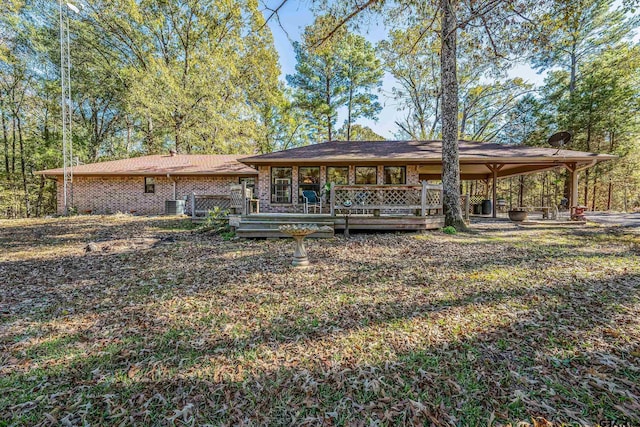 back of property featuring a wooden deck and cooling unit