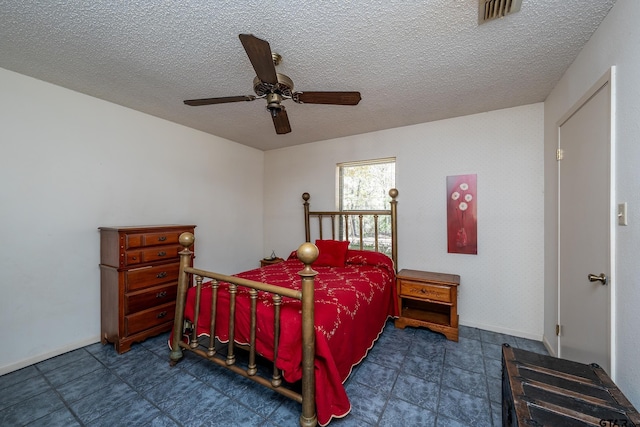 bedroom featuring a textured ceiling and ceiling fan