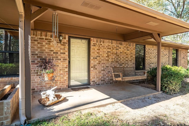 doorway to property with a patio area