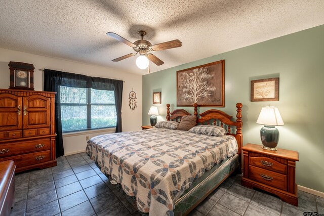 tiled bedroom with a textured ceiling and ceiling fan