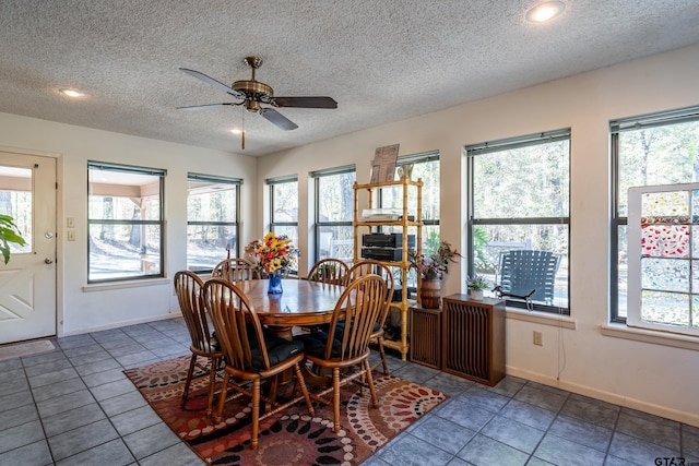 dining room with ceiling fan, a healthy amount of sunlight, and a textured ceiling