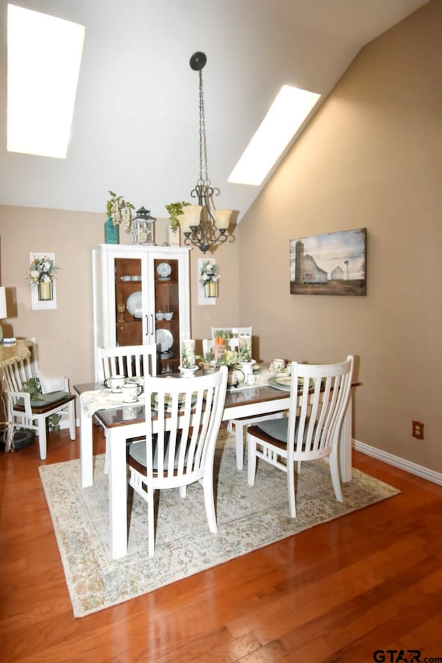 2333 Baretta Dr, Mesquite, TX 75181 - dining area with a skylight, lofted ceiling, wood finished floors, and a chandelier
