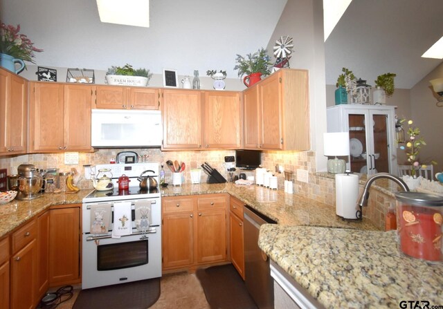 2333 Baretta Dr, Mesquite, TX 75181 - kitchen with white appliances, decorative backsplash, light stone counters, and lofted ceiling