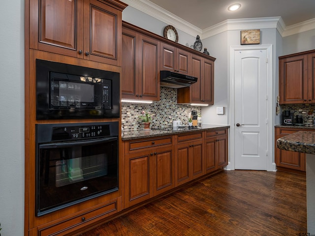 1857 Stonecrest Blvd, Tyler, TX 75703 - kitchen featuring black appliances, under cabinet range hood, decorative backsplash, dark wood-type flooring, and dark stone counters