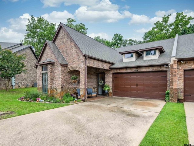 1857 Stonecrest Blvd, Tyler, TX 75703 - view of front of property featuring roof with shingles, brick siding, concrete driveway, a garage, and a front lawn