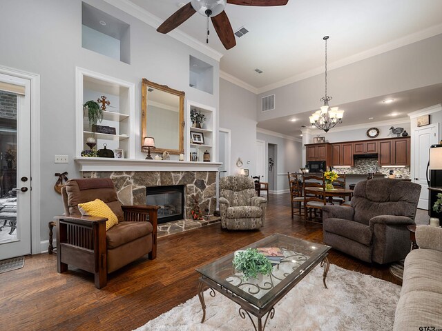 1857 Stonecrest Blvd, Tyler, TX 75703 - living room with ornamental molding, a ceiling fan, a fireplace, a chandelier, and dark wood finished floors