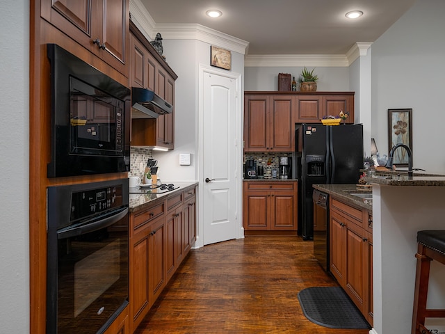 1857 Stonecrest Blvd, Tyler, TX 75703 - kitchen with black appliances, backsplash, dark stone counters, dark wood-style floors, and under cabinet range hood