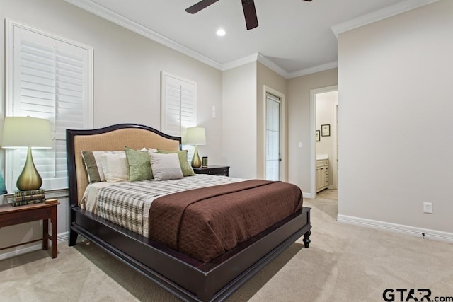 carpeted bedroom featuring ensuite bathroom, ceiling fan, and crown molding