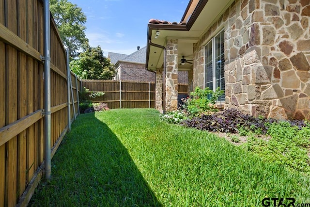 view of yard with ceiling fan