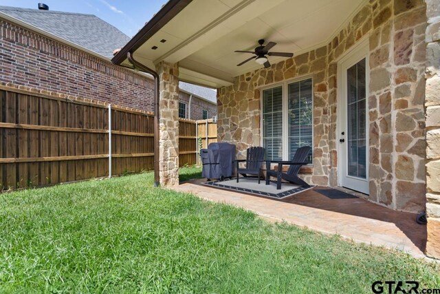 view of yard with a patio and ceiling fan