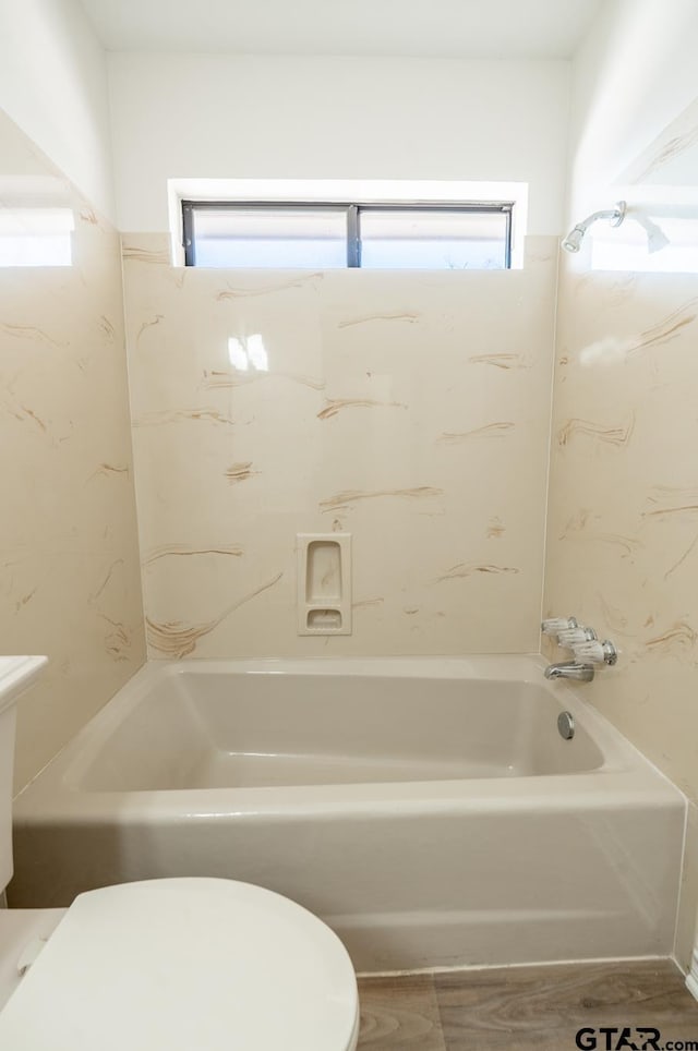 bathroom featuring toilet and shower / washtub combination