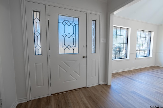 entryway with wood finished floors and baseboards