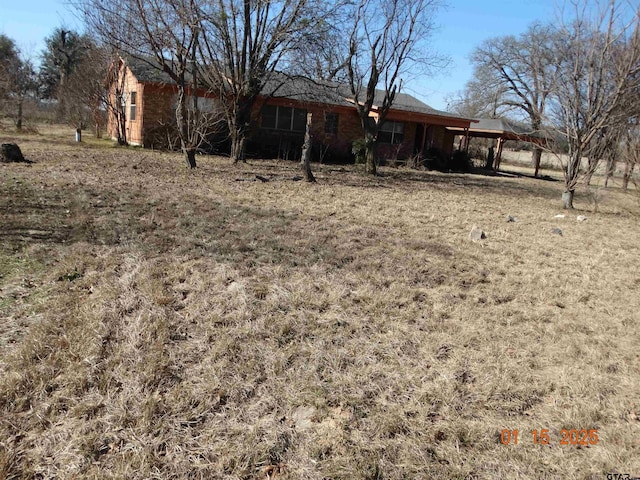 view of yard with an attached carport